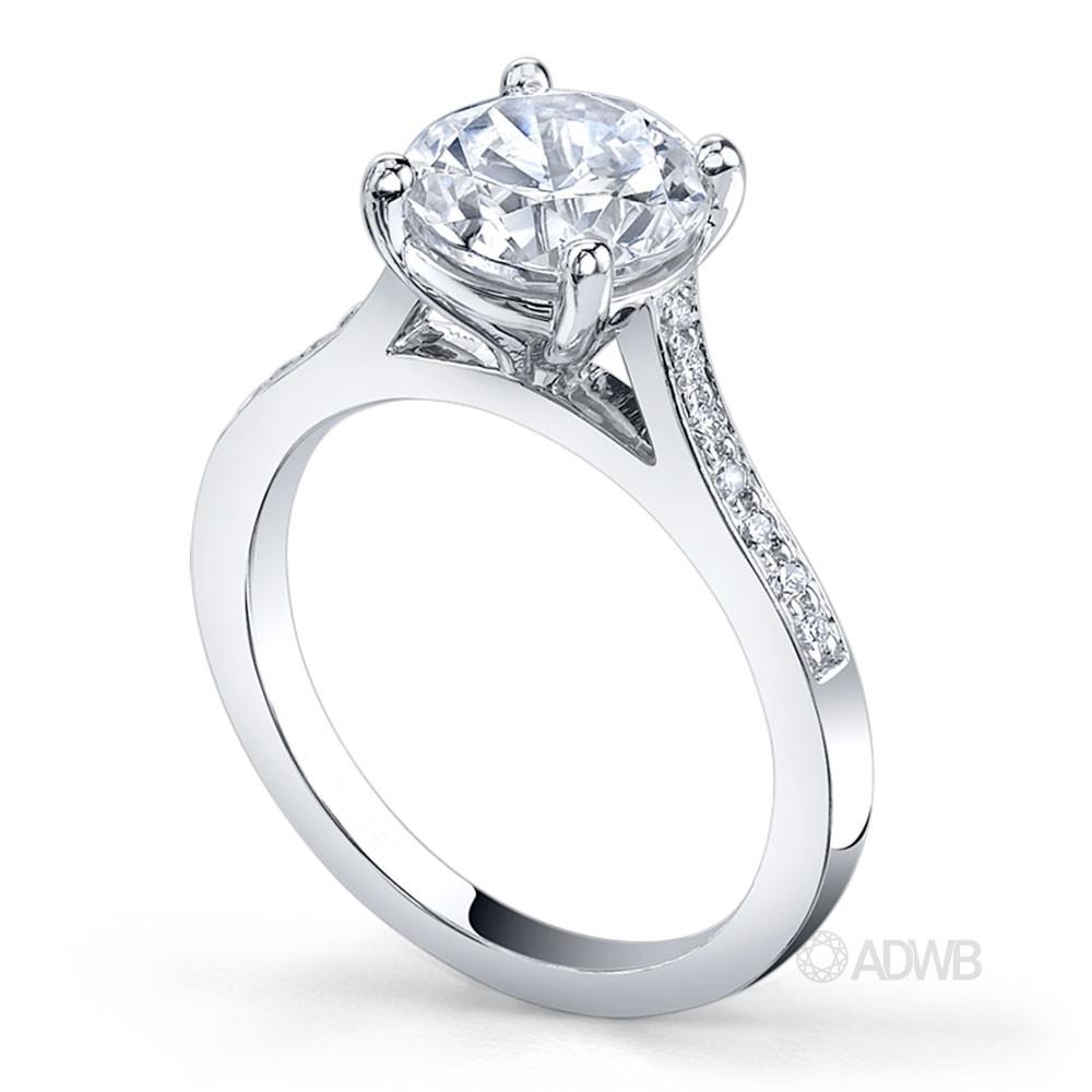 Traditional round brilliant cut diamond ring with grain set diamonds in the band