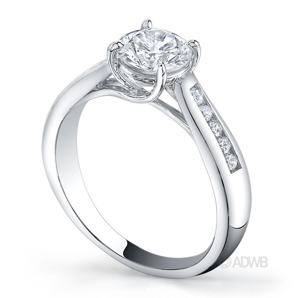 Star 4 claw round brilliant cut diamond solitaire ring with channel set tapered band