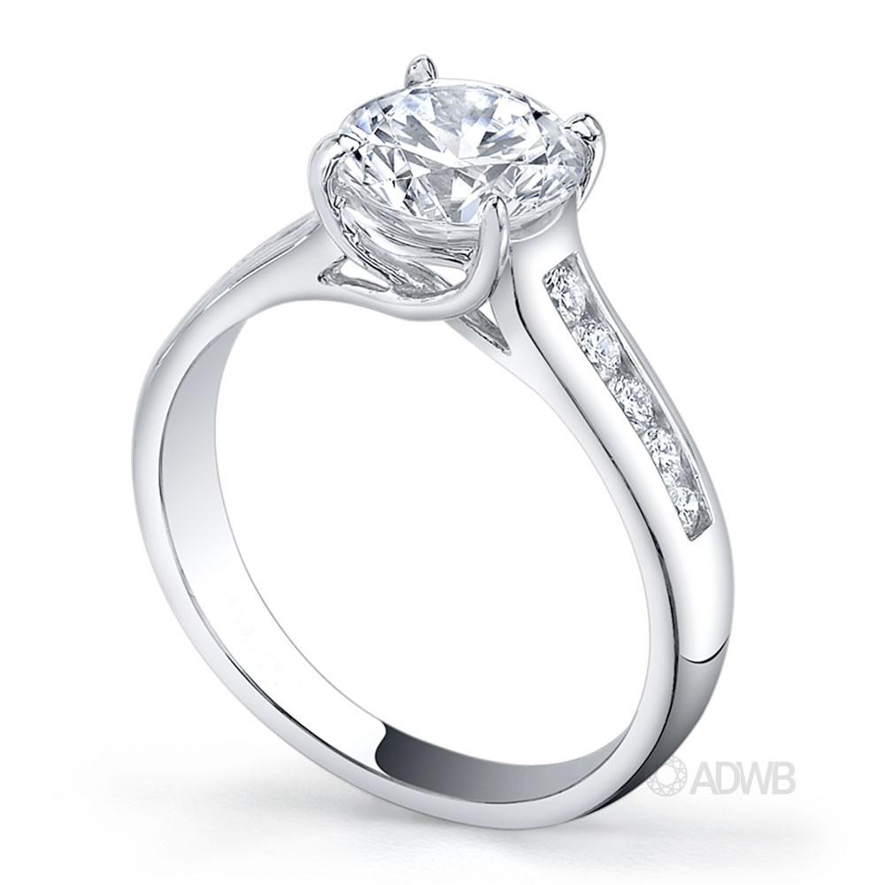 Star 4 claw round brilliant cut diamond solitaire ring with channel set band