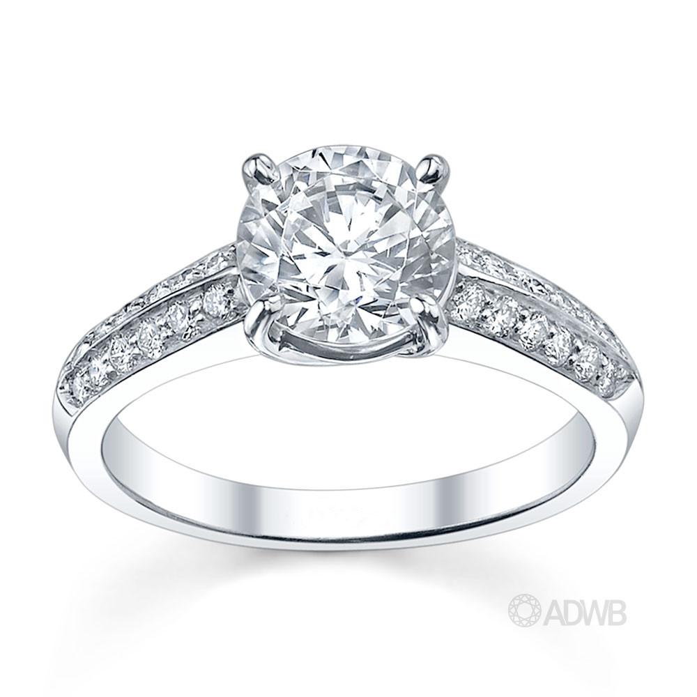 Surprise round brilliant cut diamond ring with knife edge diamond band