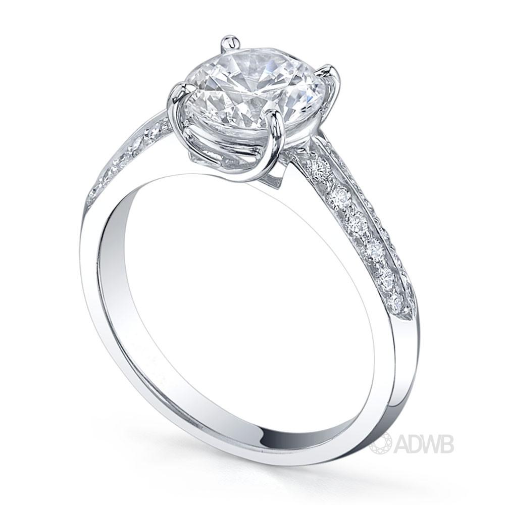 Surprise round brilliant cut diamond ring with knife edge diamond band