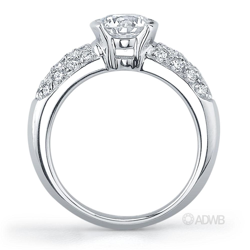 Half bezel set round brilliant cut diamond solitaire ring with pave set band