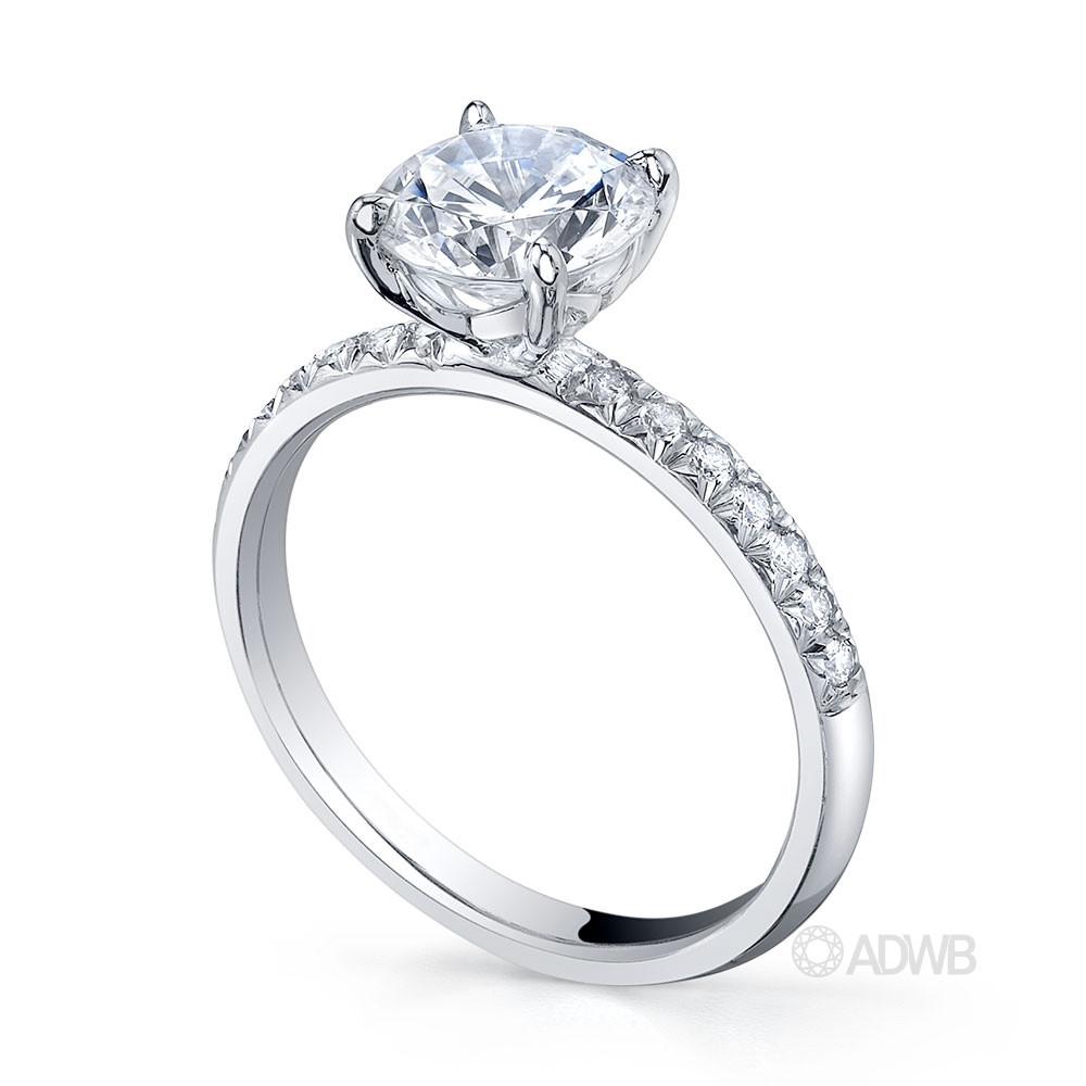 Zara round brilliant cut diamond solitaire ring with pave set diamond band