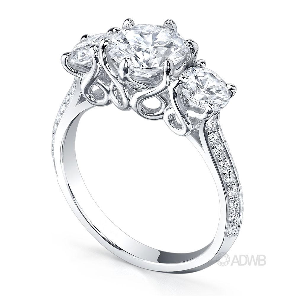 Elegant 3 stone round brilliant cut diamond ring with knife edge grain set diamond band