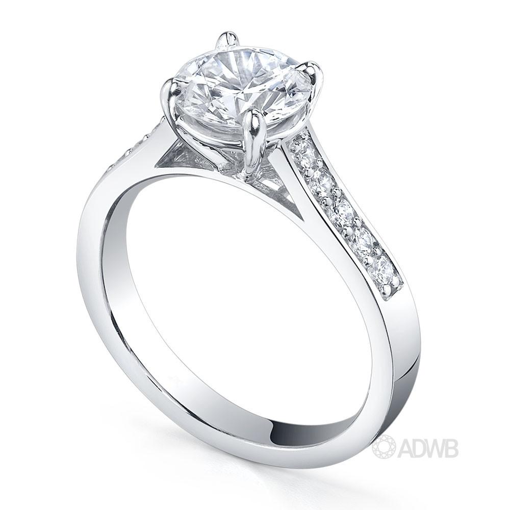 Traditional round brilliant cut diamond ring with bead set diamond band