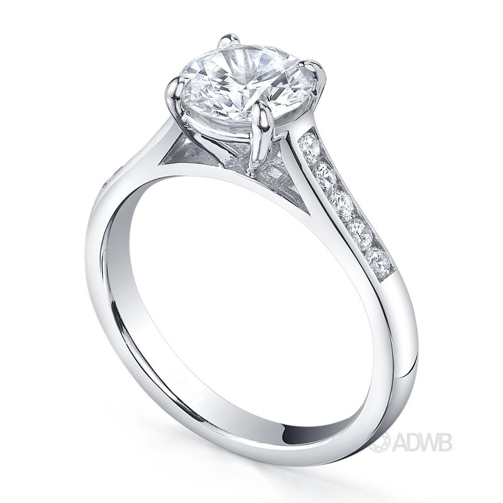 Traditional round brilliant cut diamond ring with channel set diamond band