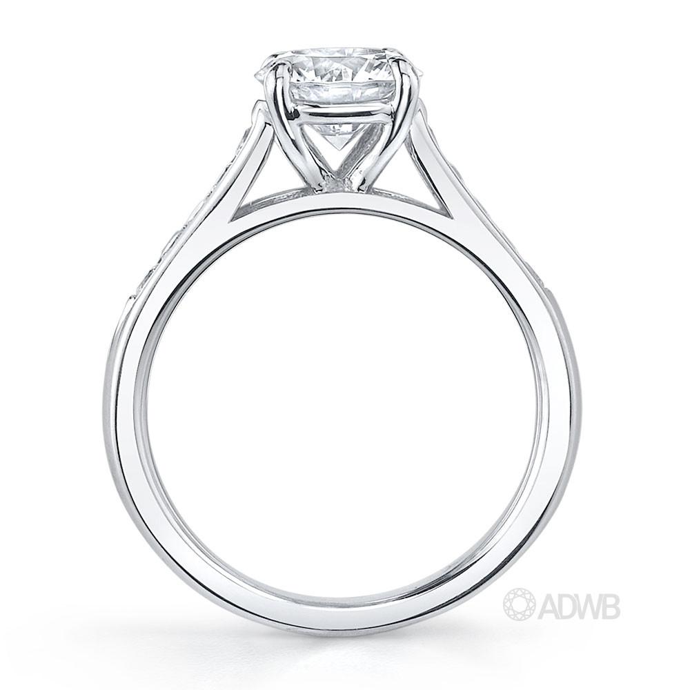 Traditional round brilliant cut diamond ring with channel set diamond band
