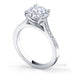 Traditional round brilliant cut diamond ring with grain set diamonds in the band