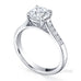 Traditional round brilliant cut diamond ring with channel set diamond band